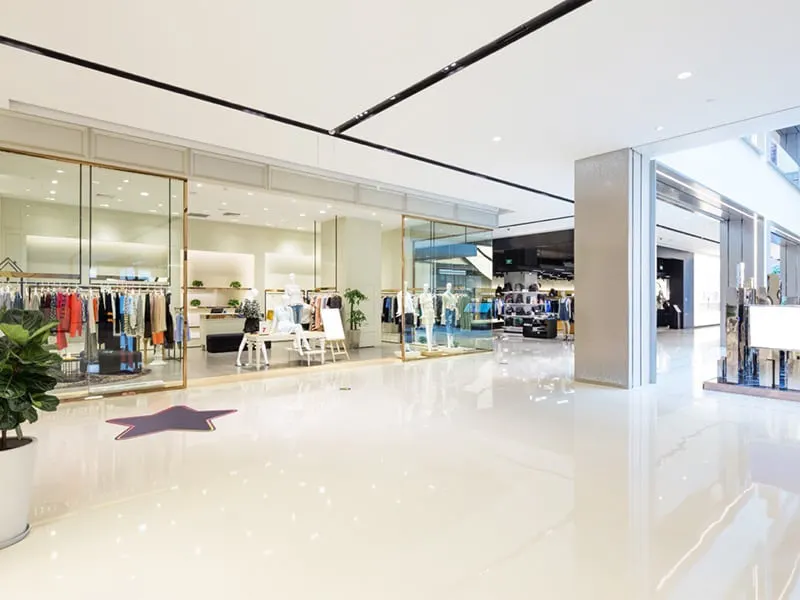 an empty corridor in an indoor shopping mall