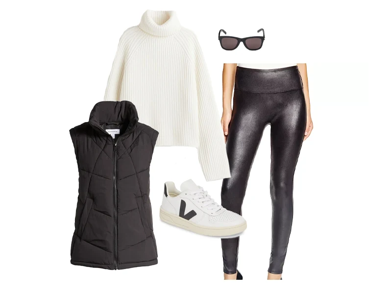 Black puffer vest with black faux leather leggings, cream turtleneck sweater, black and white sneakers, and black sunglasses