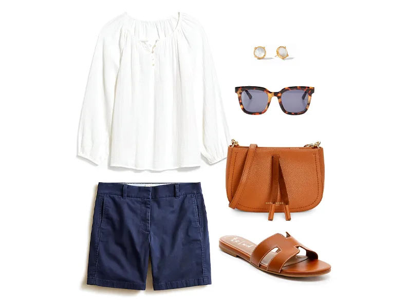 White Shirred Blouse, navy chino shorts, tan leather slides, tan leather crossbody, tortoiseshell sunglasses, and clear and gold studs