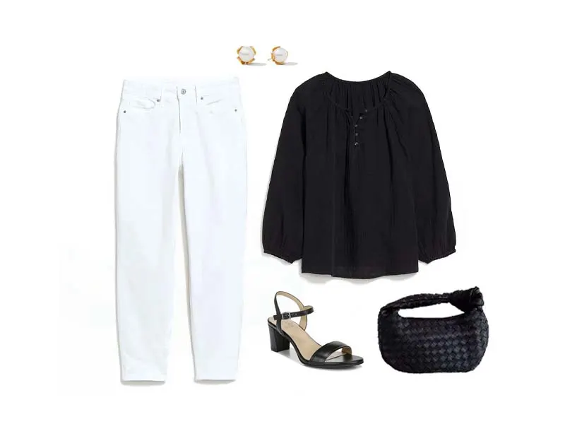 White jeans, pearl studs, black shirred blouse, black heeled sandals, and a black clutch