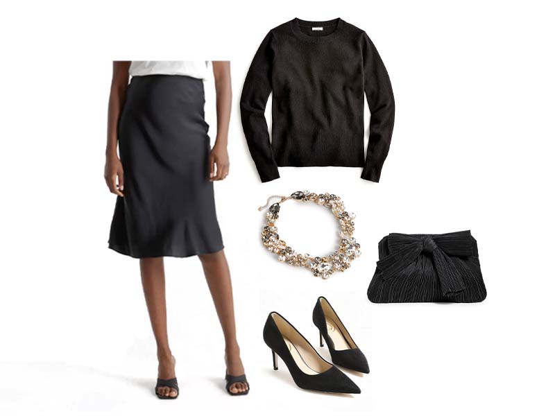 black silk shirt, black crewneck sweater, clear cluster statement necklace, black kitten heels, and black pleated clutch