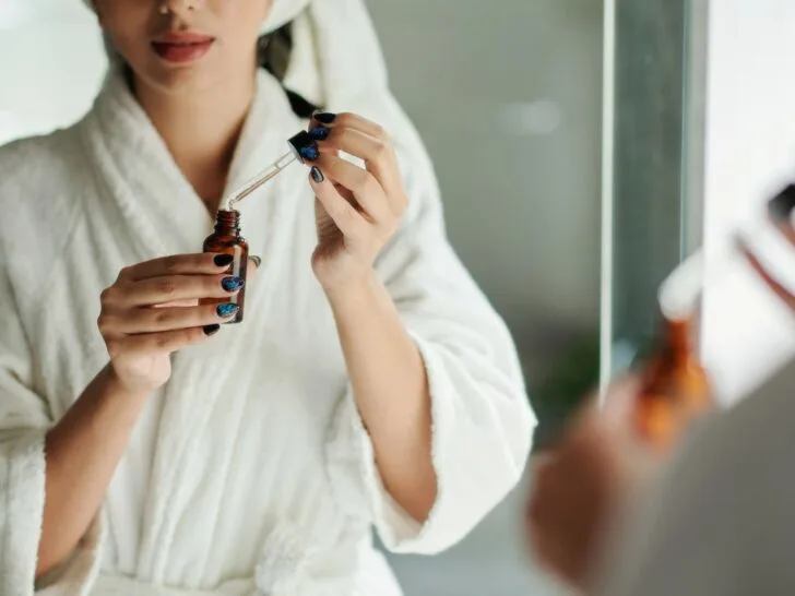 Woman applying vitamin C serum as part of a morning skincare routine