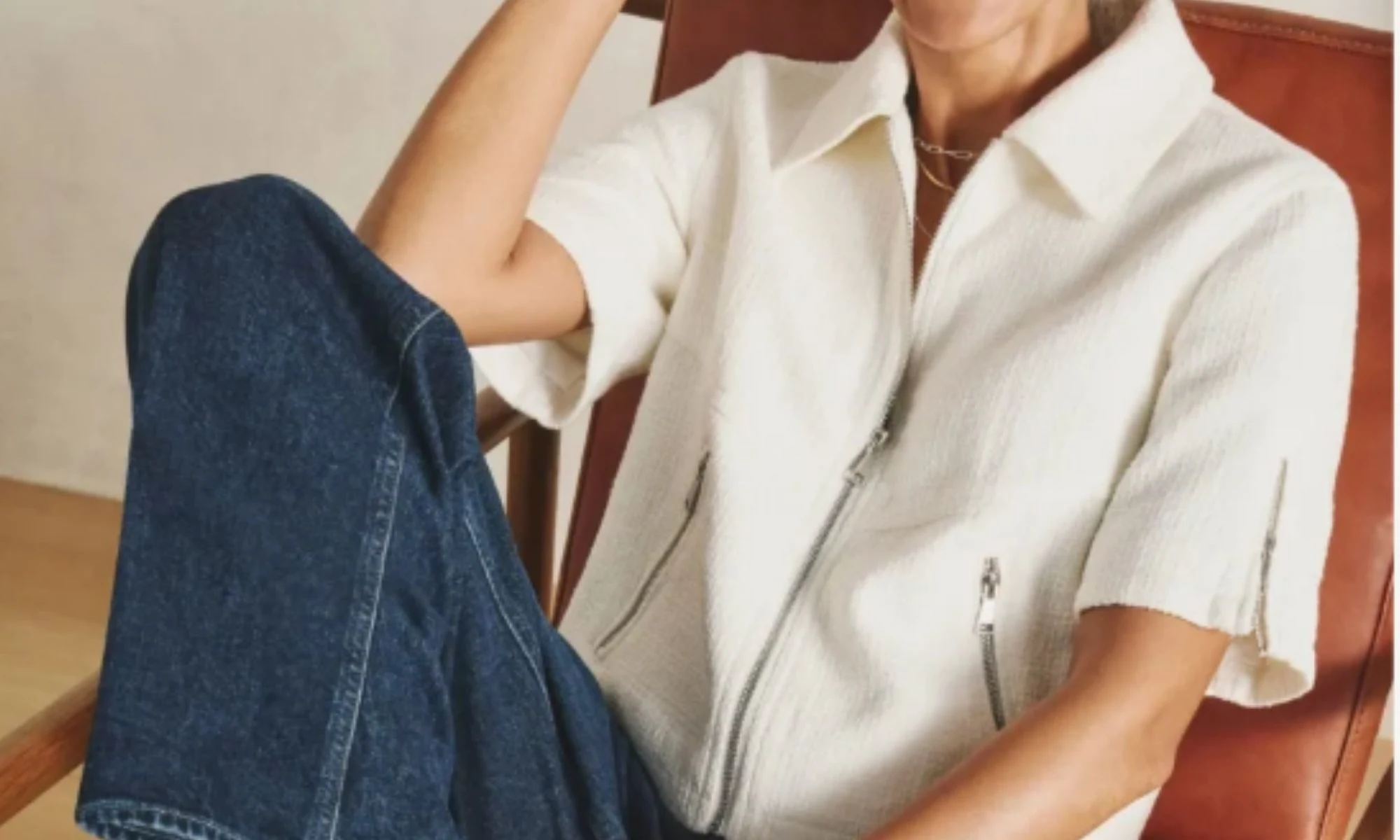 Modern white jacket styled with dark denim, polished casual style for women over 40