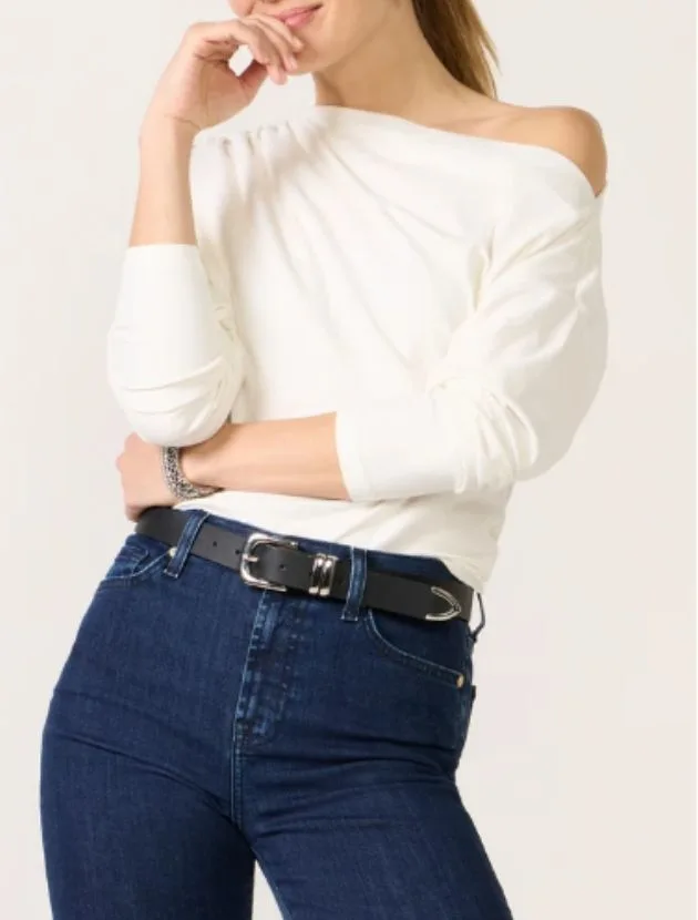 White one-shoulder top styled with jeans, an elevated date night top for women over 40