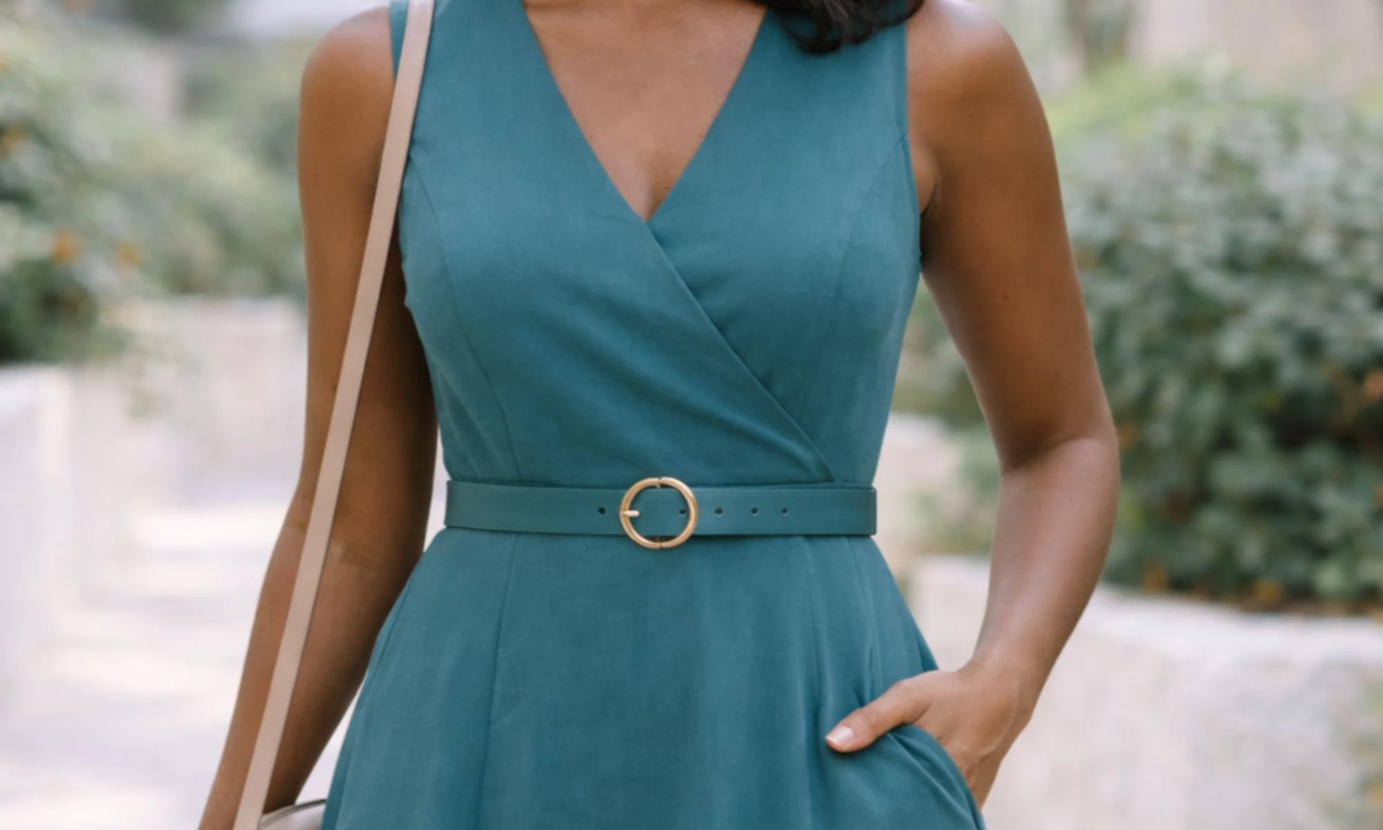 Woman wearing a wrap-style dress that highlights natural curves, illustrating balanced proportions for an hourglass body type