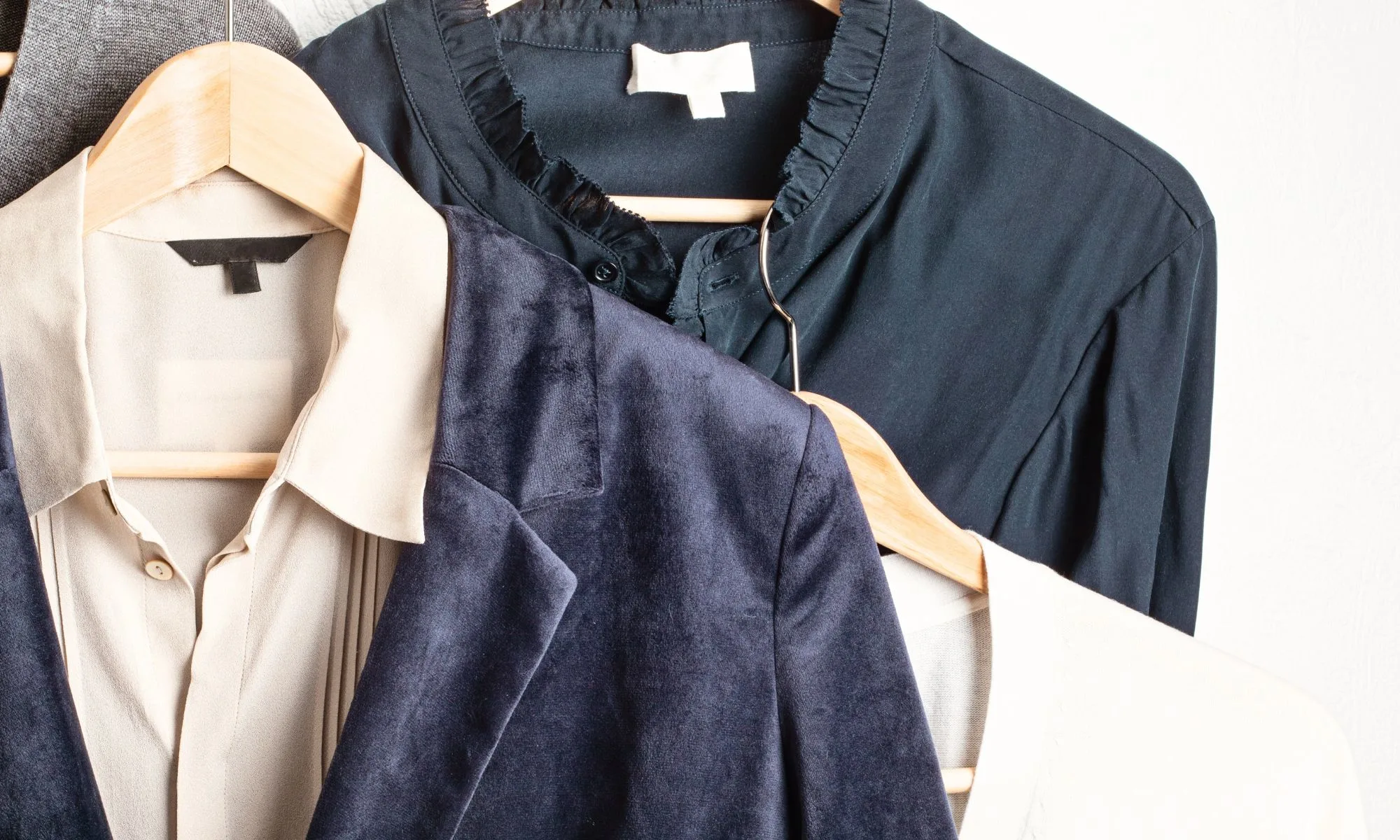 organized wardrobe with blazers and neutral basics illustrating how to shop your closet