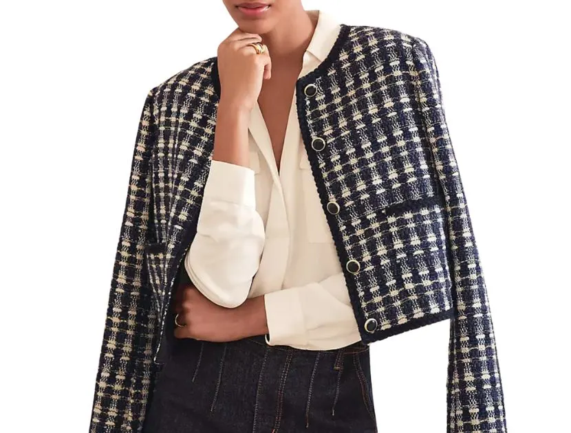 Woman wearing Ann Taylor navy plaid tweed patch pocket jacket with white blouse and dark jeans