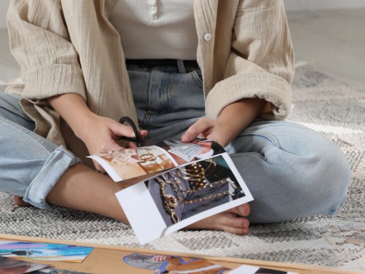 woman cutting magazine images to create a fashion vision board
