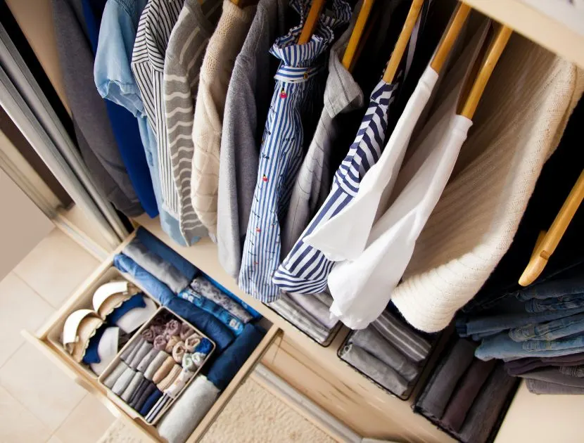 An organized wardrobe showing hanging and folded essentials arranged for everyday use.