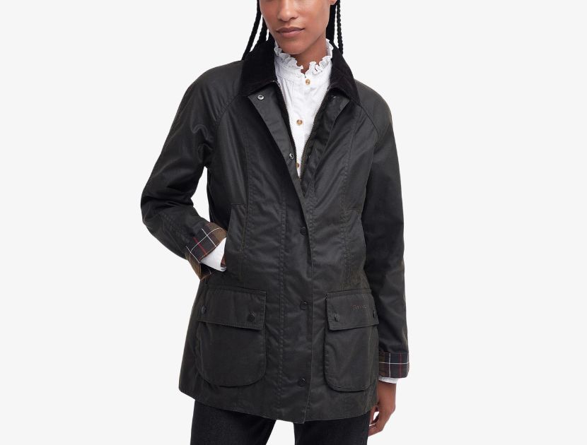 Woman wearing Barbour Classic Beadnell Waxed Jacket in olive with corduroy collar and front pockets, a durable water-resistant fall coat for women over 4