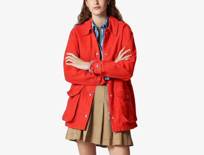 Woman wearing J.Crew broken-in barn jacket in bright scarlet chino with oversized pockets, a timeless utility coat for women over 40.