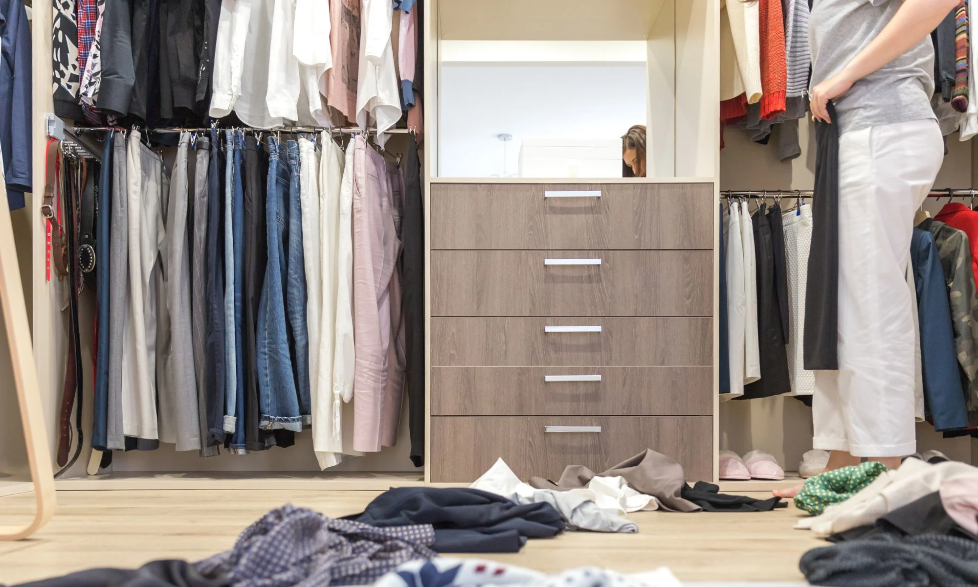 Closet clean-out in progress with clothes sorted on the floor