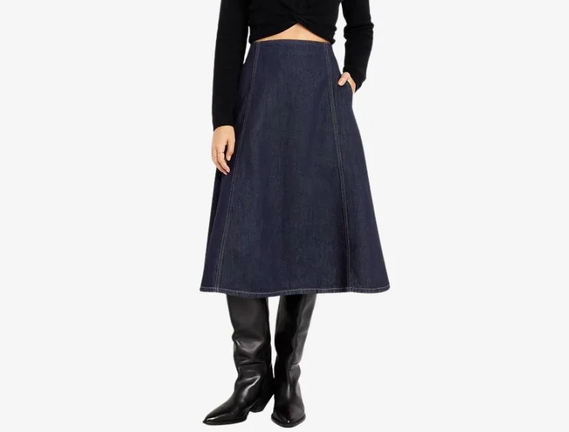 Dark rinse denim midi skirt from Old Navy styled with a black fitted top and tall black boots, a wearable denim trend for 2025.