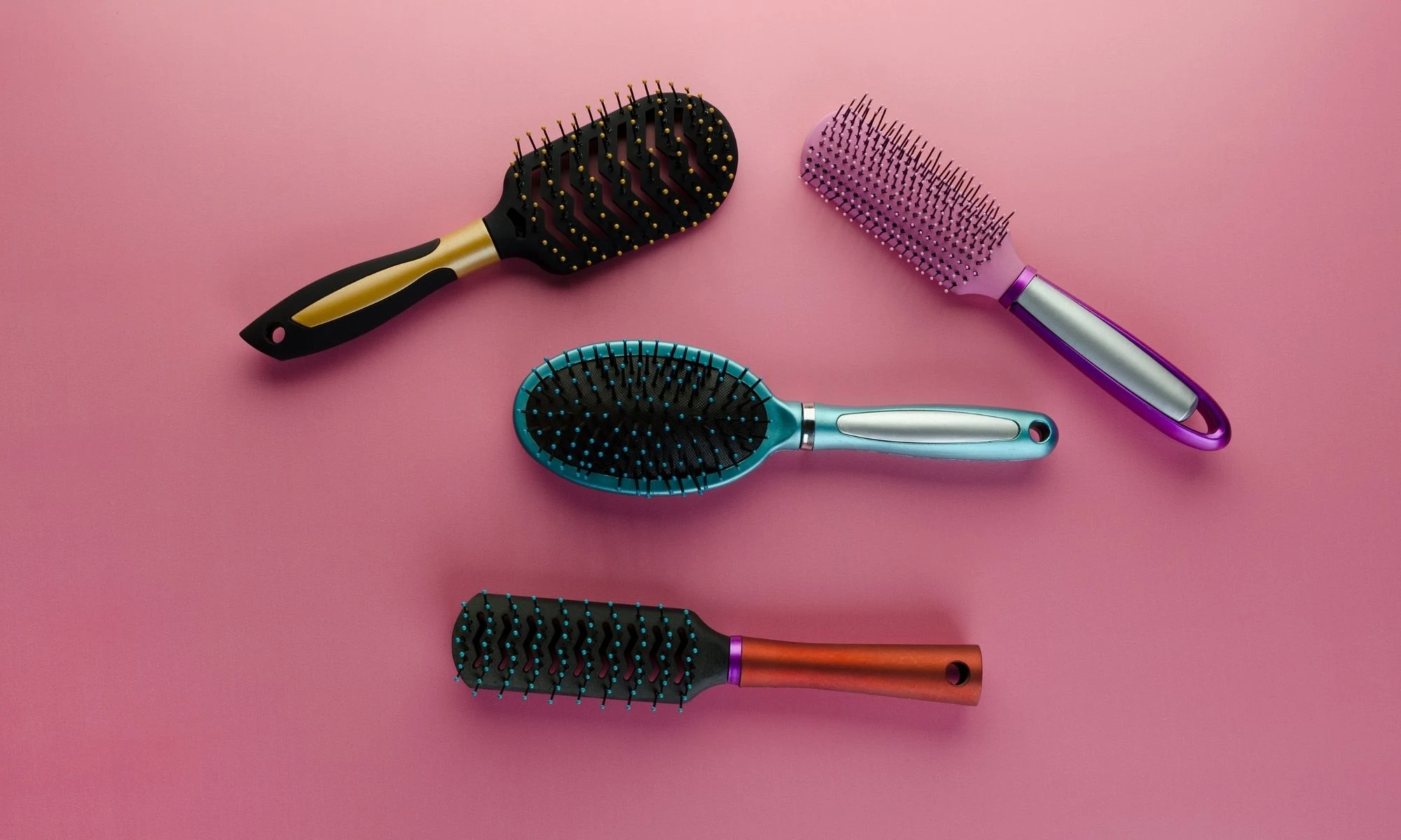 Assorted hair brushes used for detangling, smoothing, and styling different hair types