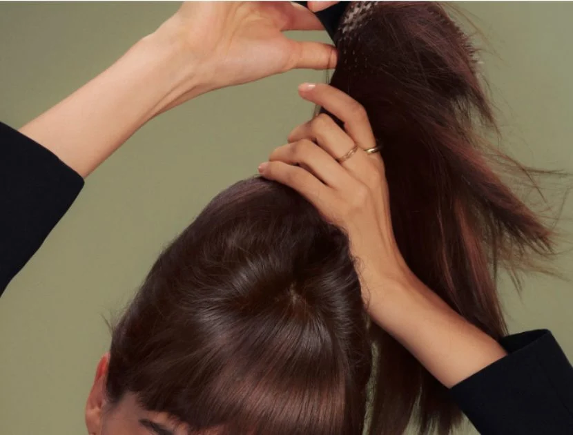 Boar bristle hair brush smoothing hair to reduce frizz and add shine