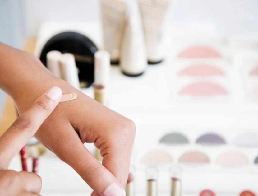 Warming concealer on the back of the hand to test shade and prepare product before application