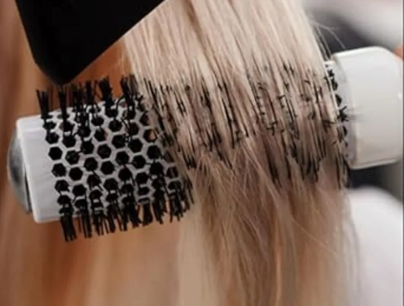 Round brush used while blow-drying hair to create smooth volume and shape