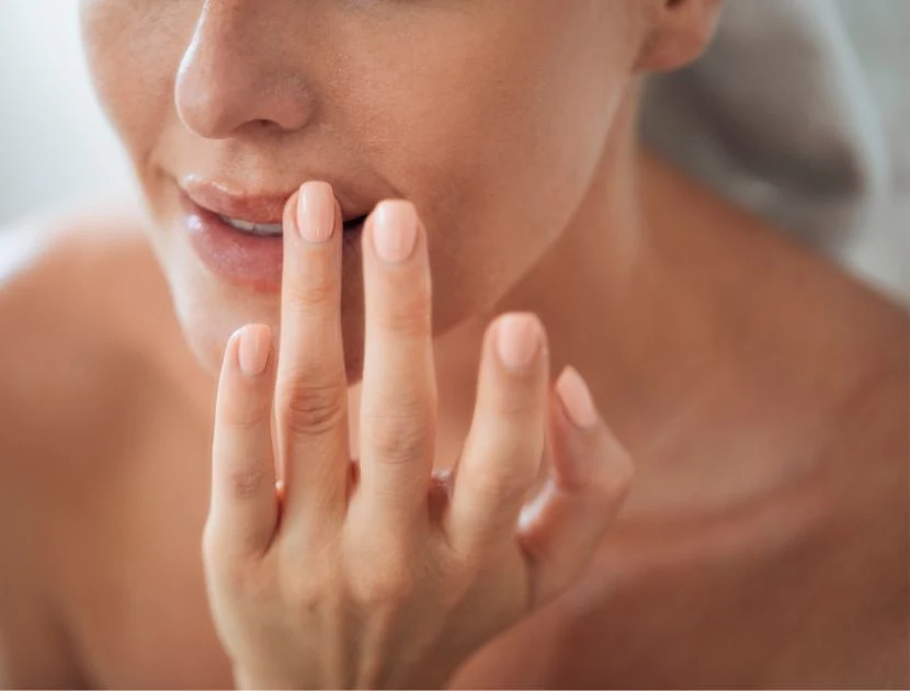 Woman applying treatment to the skin around her lips