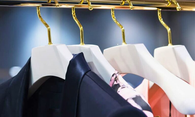 Structured wardrobe with investment pieces on brass hangers