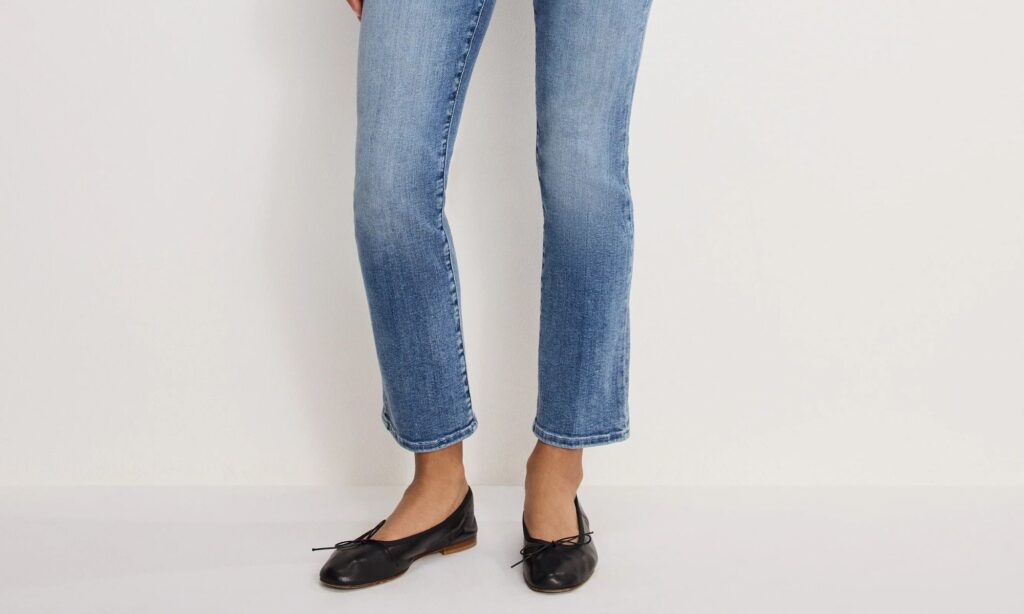 Straight leg ankle jeans in medium blue wash styled with black ballet flats