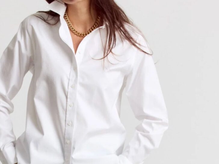 Oversized white button-down shirt styled with a gold chain necklace